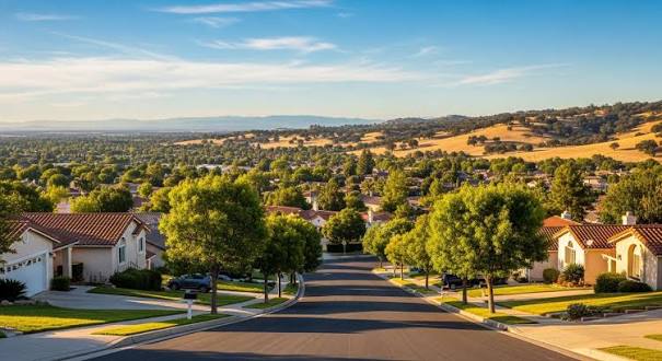 Sunlit suburban street overlooking green valley and golden hills in la puente